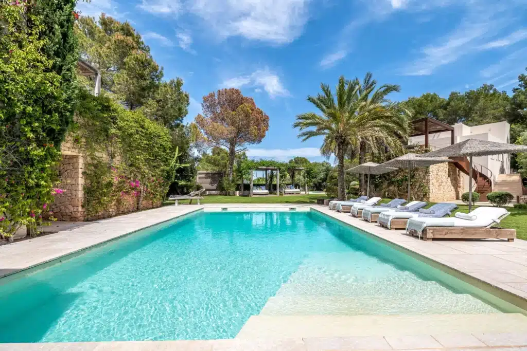 villa wenya pool surrounded by trees and blue sky