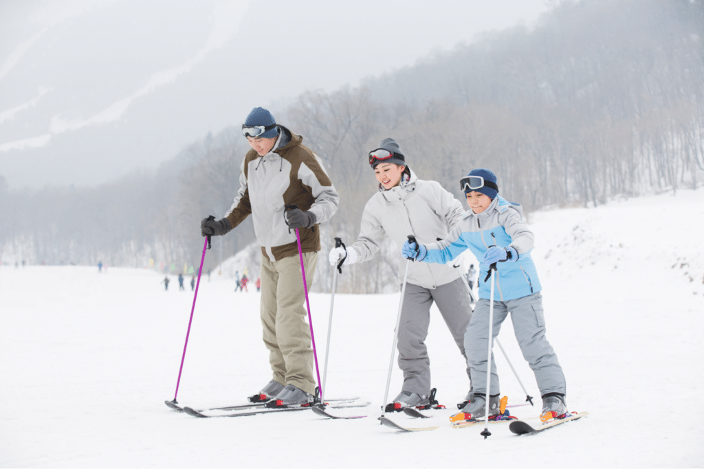 young-family-skiing-in-ski-resort-2023-11-27-04-56-10-utc young family skiing